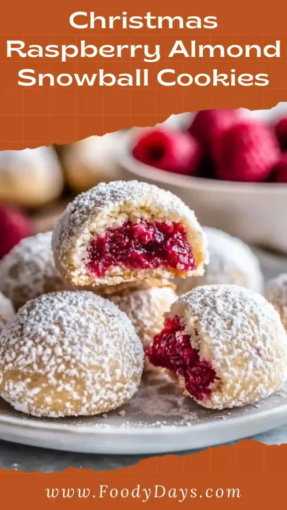 Christmas Raspberry Almond Snowball Cookies with raspberry filling and powdered sugar