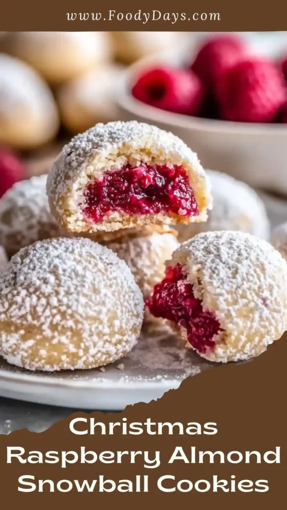 Christmas Raspberry Almond Snowball Cookies with raspberry filling and powdered sugar