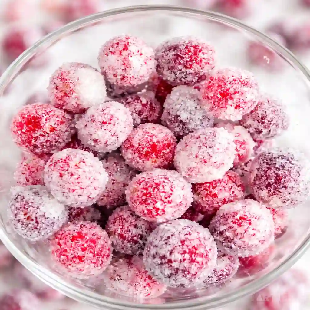 Orange vanilla candied cranberries sparkling with sugar for holiday desserts