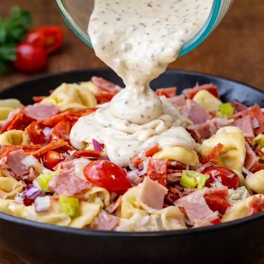 Italian Grinder Tortellini Salad served family style with tortellini and Italian meats