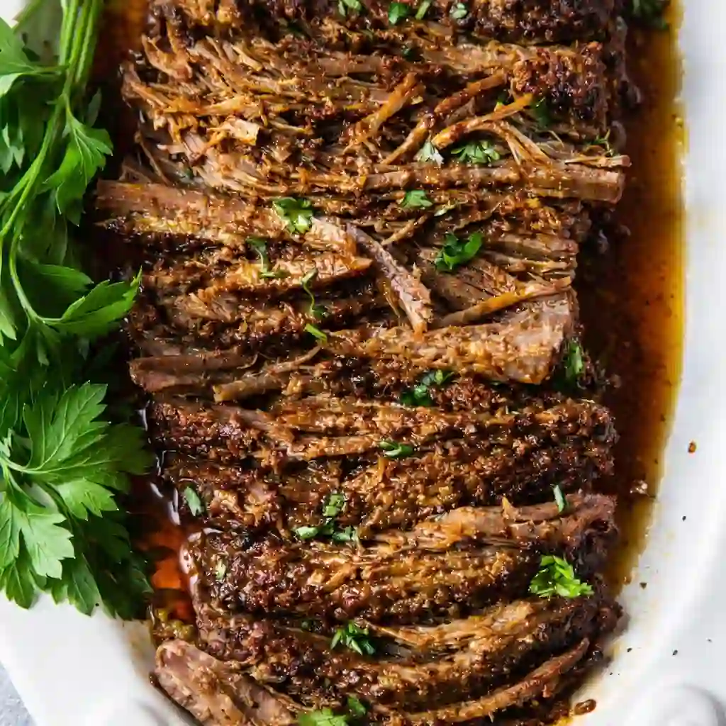 Family-friendly slow cooked beef brisket tender and juicy on white marble background