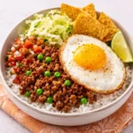 Homemade Boy Kibble recipe with ground beef, jasmine rice, and bone broth in a meal prep bowl.
